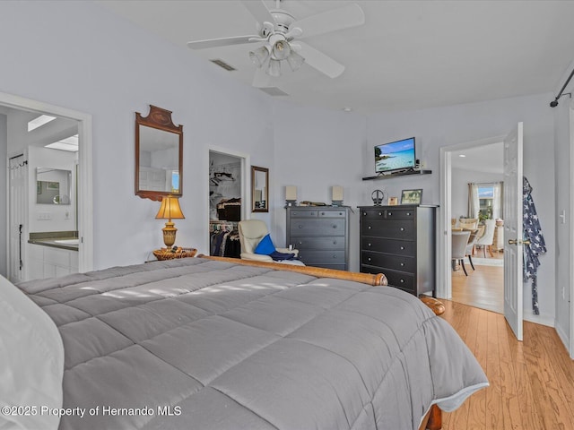 bedroom with ceiling fan, a closet, and light hardwood / wood-style flooring