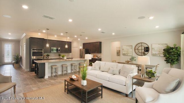 living room featuring crown molding and light tile patterned floors