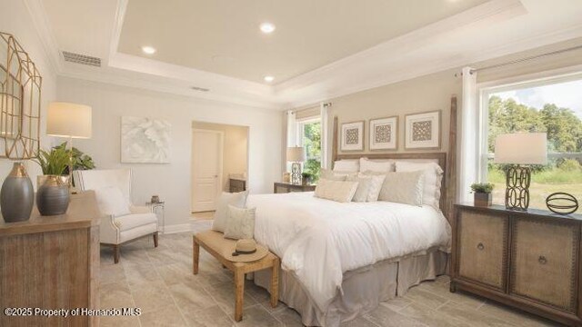 bedroom featuring ornamental molding and a tray ceiling