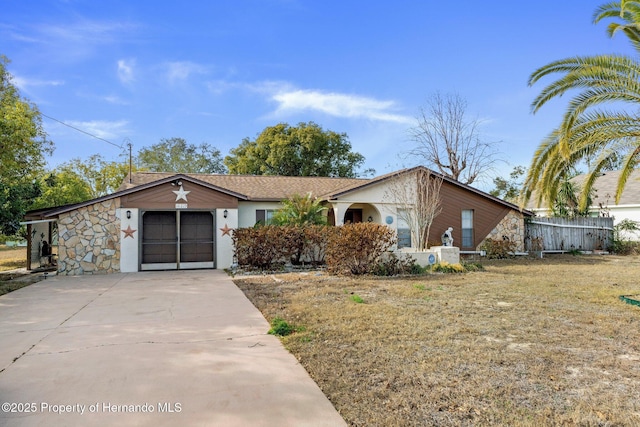 ranch-style home featuring a garage and a front lawn