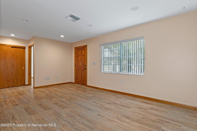 unfurnished room featuring light hardwood / wood-style floors