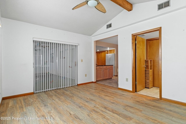 unfurnished room with ceiling fan, light hardwood / wood-style floors, and vaulted ceiling with beams