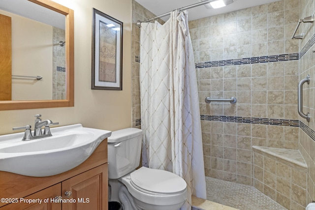 bathroom featuring vanity, toilet, and curtained shower