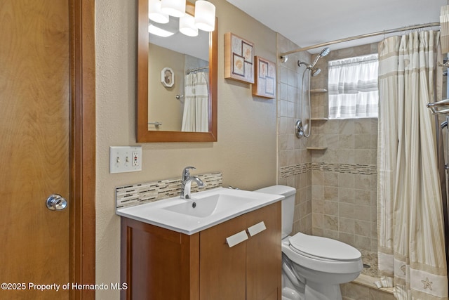 bathroom featuring vanity, toilet, and a shower with shower curtain