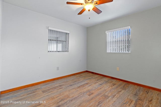 empty room featuring wood-type flooring and ceiling fan