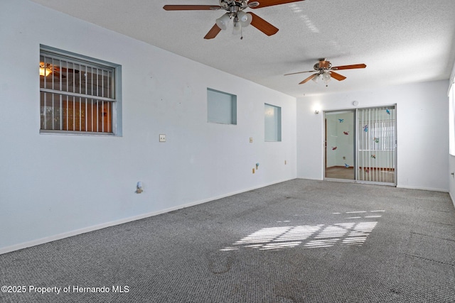 carpeted spare room with ceiling fan and a textured ceiling