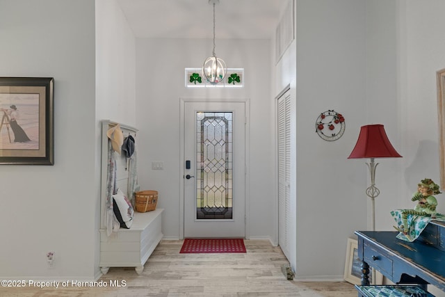 foyer with a notable chandelier and light hardwood / wood-style floors