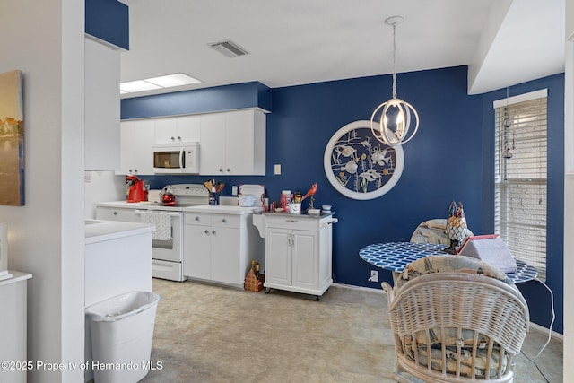 kitchen featuring an inviting chandelier, white appliances, decorative light fixtures, and white cabinets