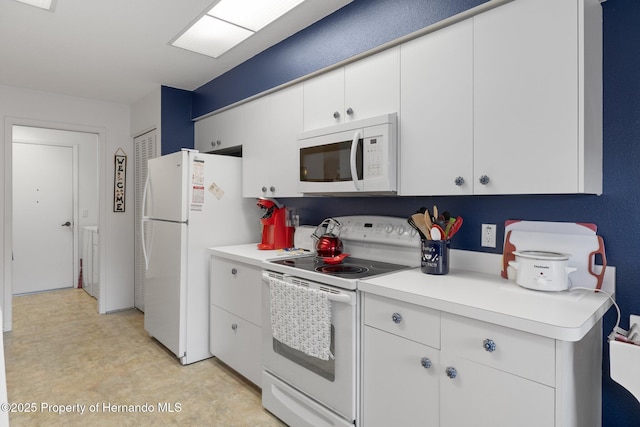 kitchen featuring white appliances and white cabinets