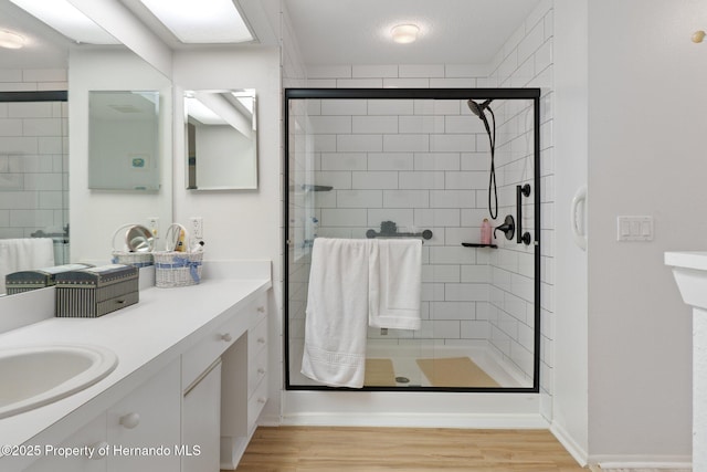 bathroom featuring vanity, wood-type flooring, and an enclosed shower