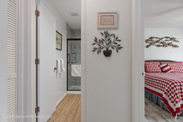 corridor with light hardwood / wood-style floors