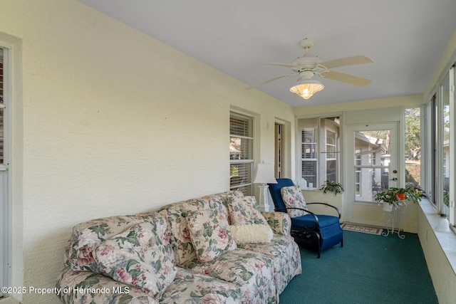 sunroom featuring ceiling fan