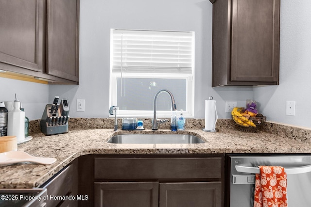 kitchen featuring dark brown cabinets, sink, and stainless steel dishwasher