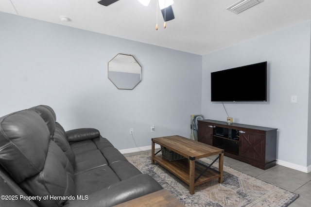 tiled living room with ceiling fan