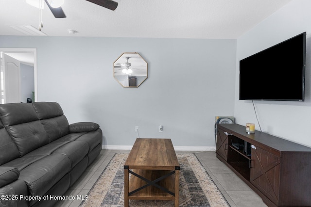 tiled living room with ceiling fan