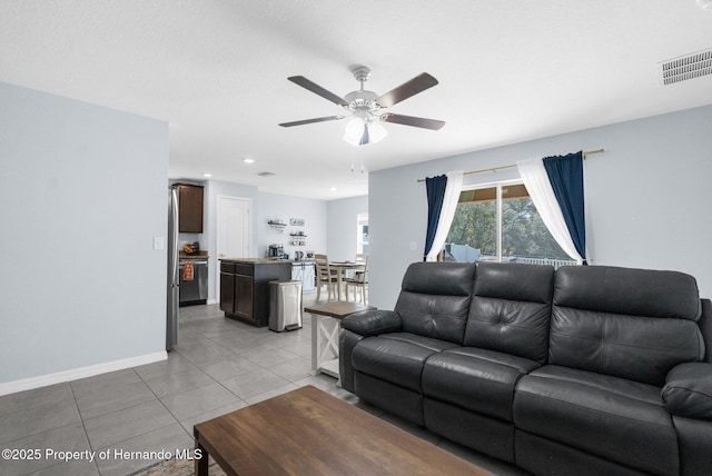 tiled living room featuring ceiling fan