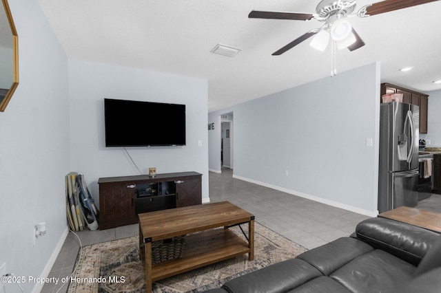 tiled living room with ceiling fan