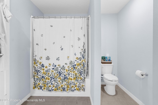 bathroom featuring toilet and tile patterned flooring