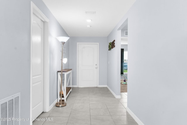 hall with light tile patterned floors