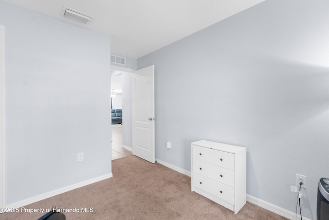 unfurnished bedroom featuring light carpet