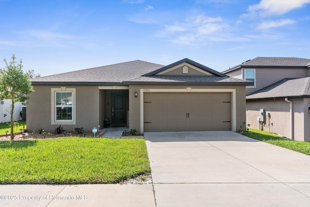 view of front of property with a garage and a front lawn