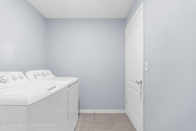 washroom featuring light tile patterned flooring and washing machine and clothes dryer