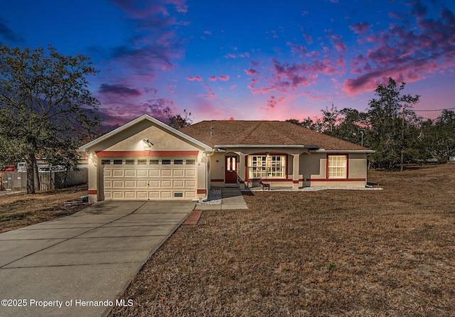 ranch-style home with a yard and a garage