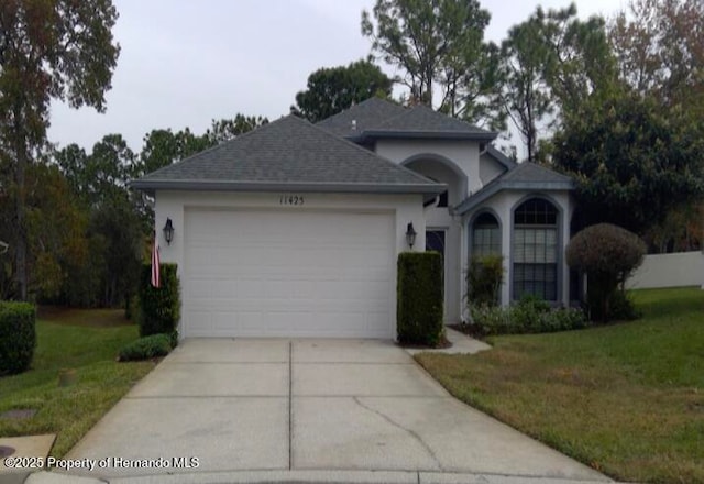 view of front facade with a garage and a front lawn