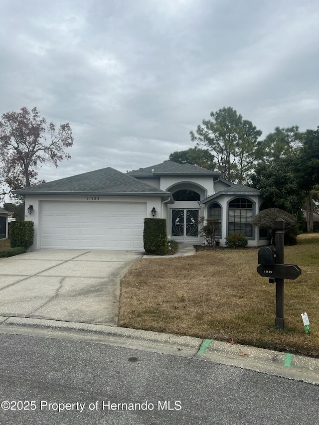 view of front of home with a garage and a front yard