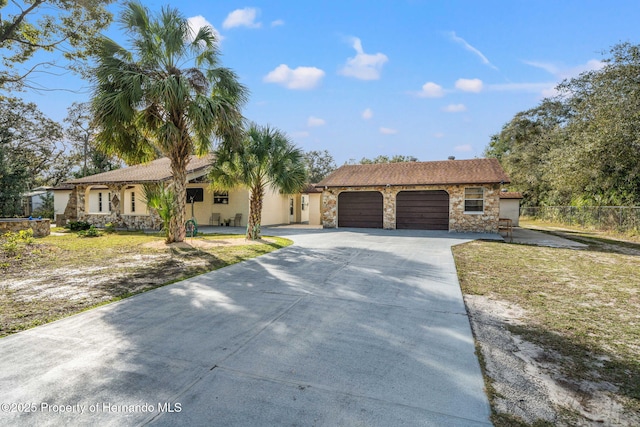 ranch-style house with a garage and a front yard