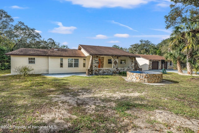 back of property featuring a yard and a patio