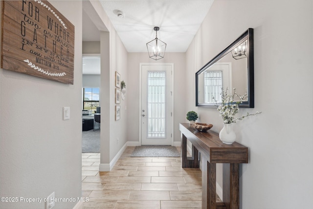 foyer entrance with a chandelier