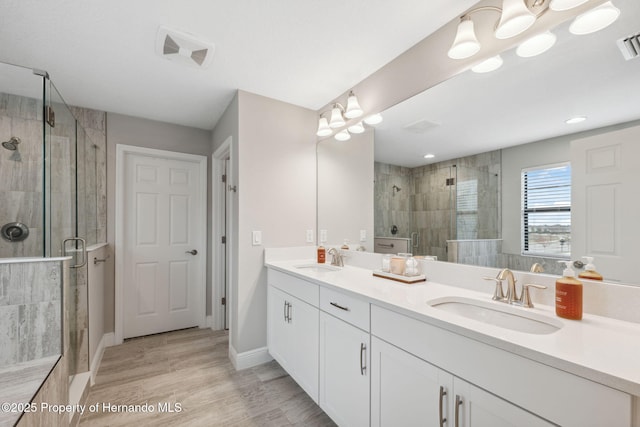 bathroom featuring vanity, hardwood / wood-style floors, and walk in shower