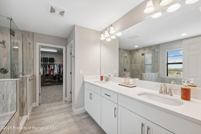 bathroom with vanity and a shower with shower door