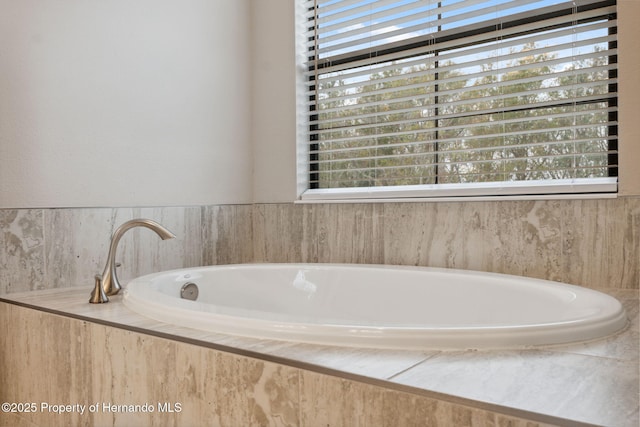 bathroom featuring tiled tub