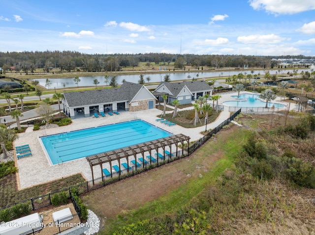 view of swimming pool with a water view and a patio