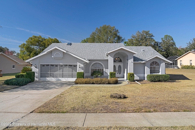 ranch-style home featuring a garage and a front lawn