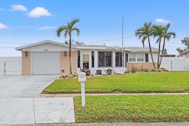 single story home with a garage and a front yard