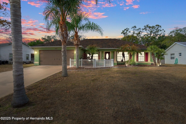 ranch-style home featuring a yard and a garage