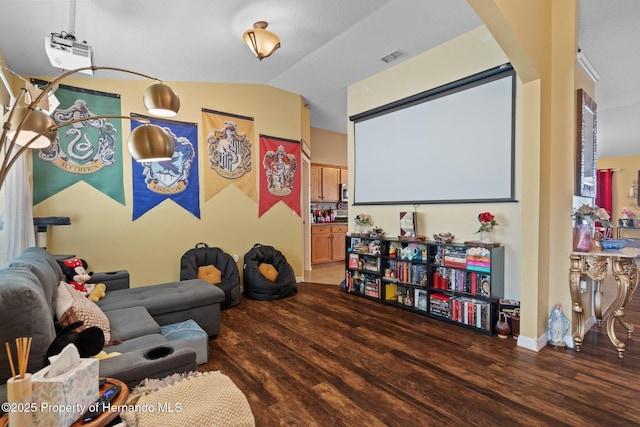 home theater featuring lofted ceiling and wood-type flooring