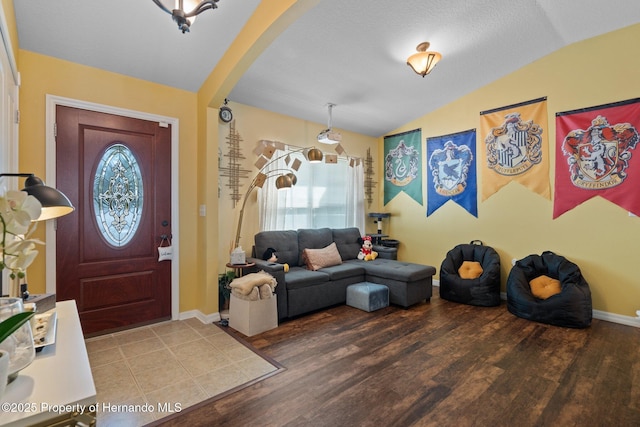 foyer entrance featuring lofted ceiling and hardwood / wood-style floors