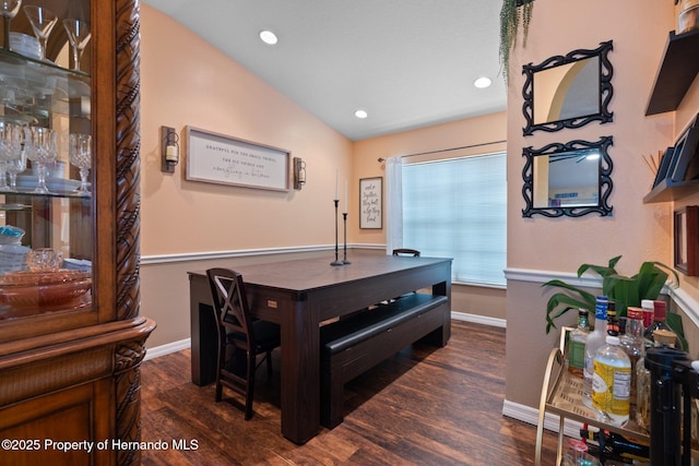 dining area featuring dark hardwood / wood-style flooring and vaulted ceiling