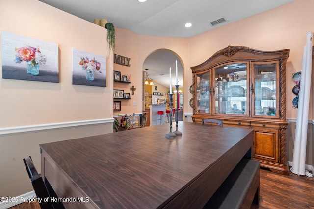 dining area with lofted ceiling and dark hardwood / wood-style flooring