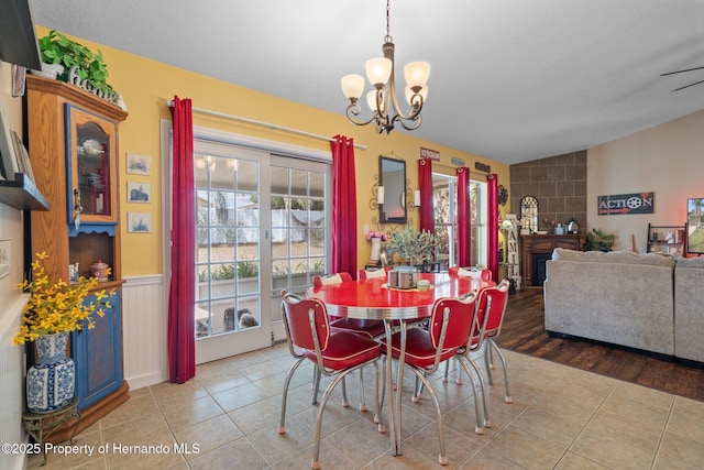 tiled dining area with an inviting chandelier