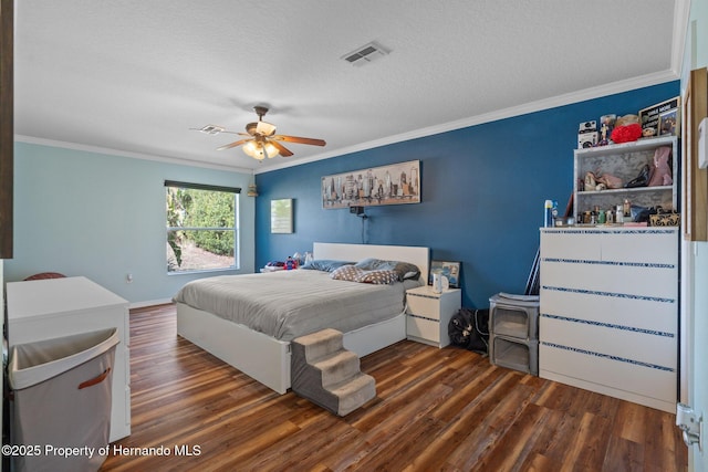 bedroom featuring crown molding, ceiling fan, dark hardwood / wood-style flooring, and a textured ceiling