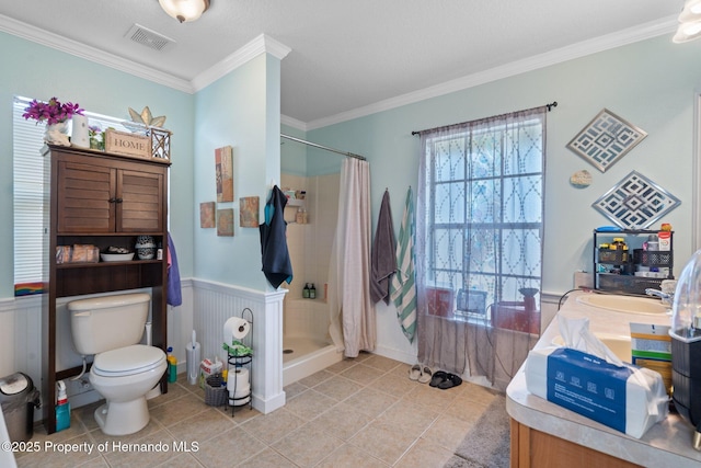 bathroom with ornamental molding, toilet, tile patterned floors, and a shower with curtain