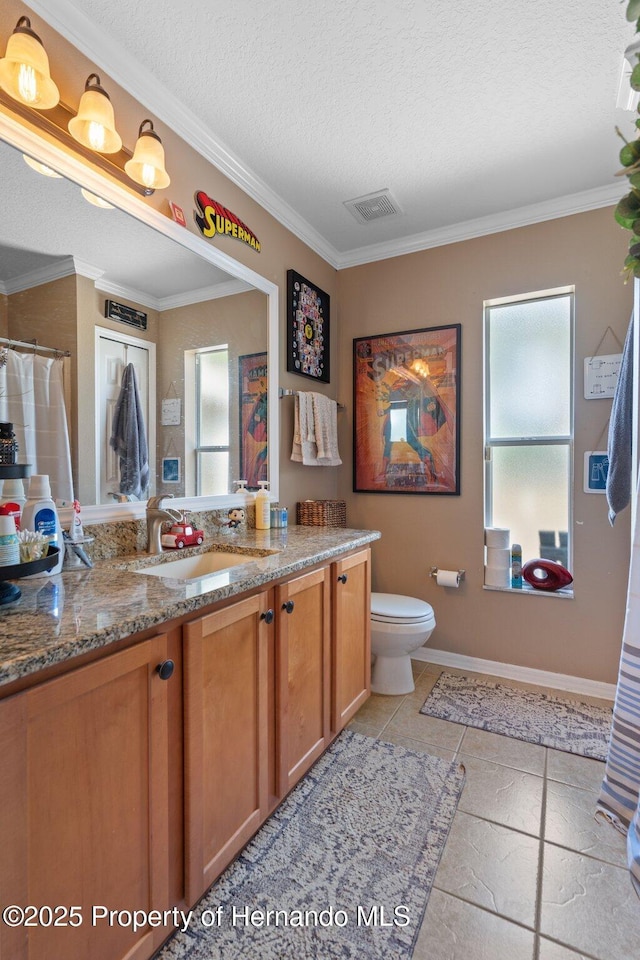 bathroom featuring plenty of natural light, toilet, vanity, and a textured ceiling