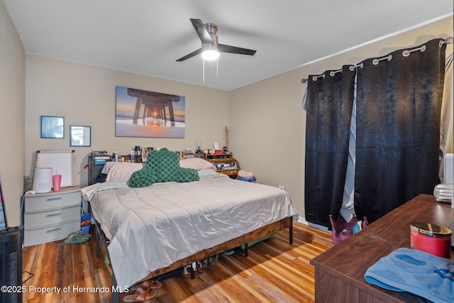 bedroom featuring hardwood / wood-style floors and ceiling fan