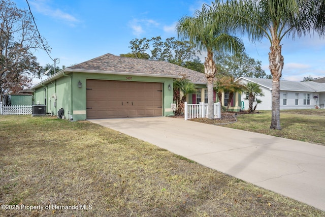 ranch-style house with a garage, central AC, and a front yard