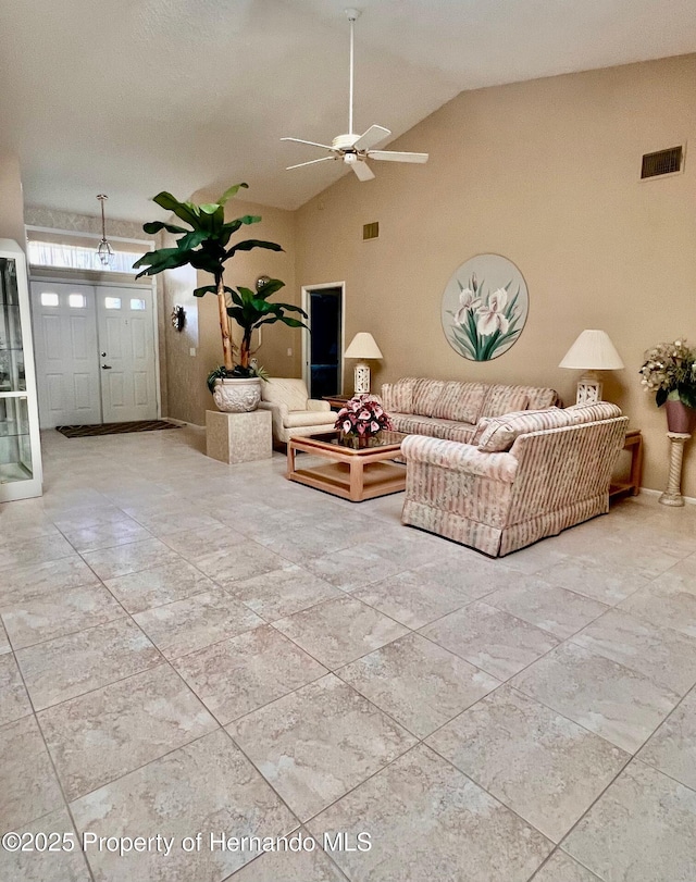 living room featuring ceiling fan and high vaulted ceiling